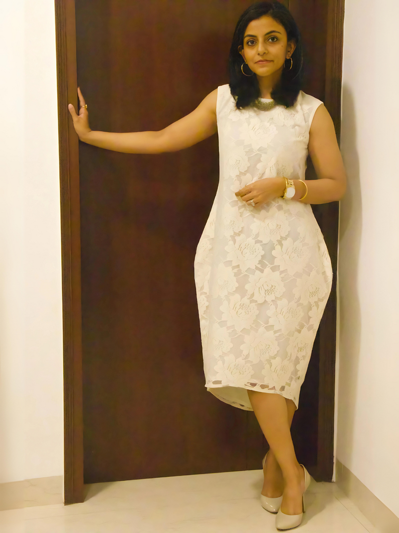 Sleeveless off-white lace dress with a longer scoop back