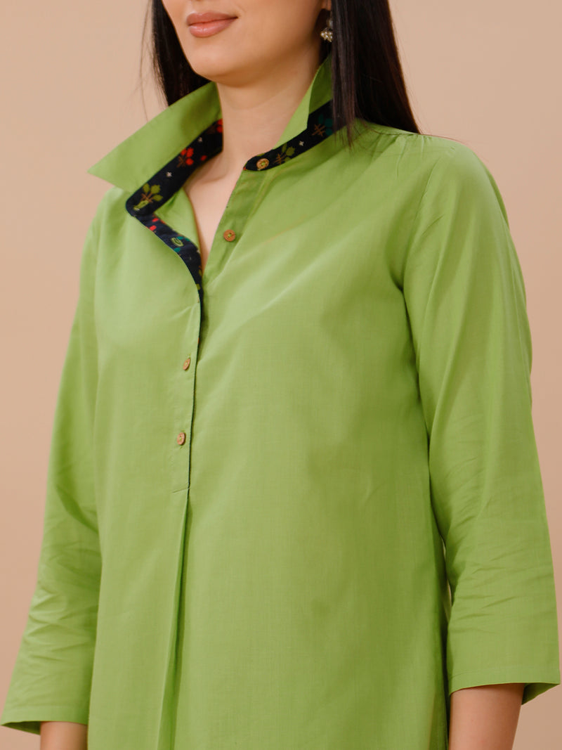 Green Cotton Kurta With Pockets And Blue Printed Fabric Inserts At Neck Band And Bottom Hem Paired With Straight Pants .