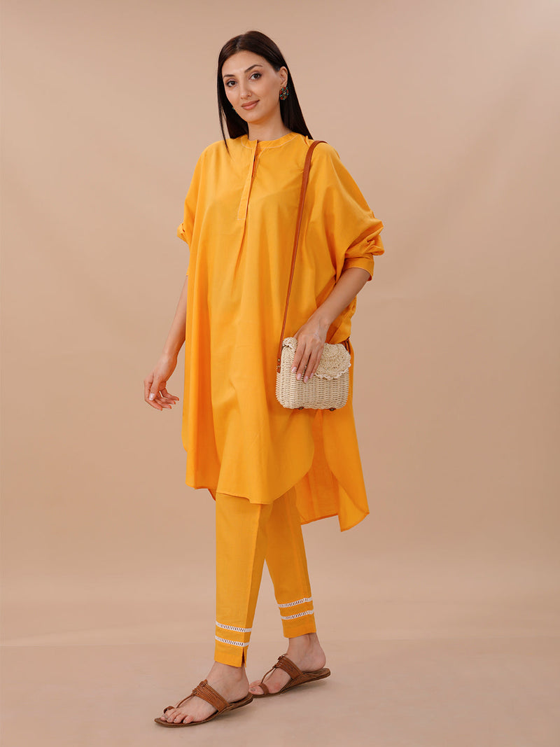 Yellow Cotton Loose Fit Kurta With Contrast Stitch Paired With Straight Pants With Lace Inserts.