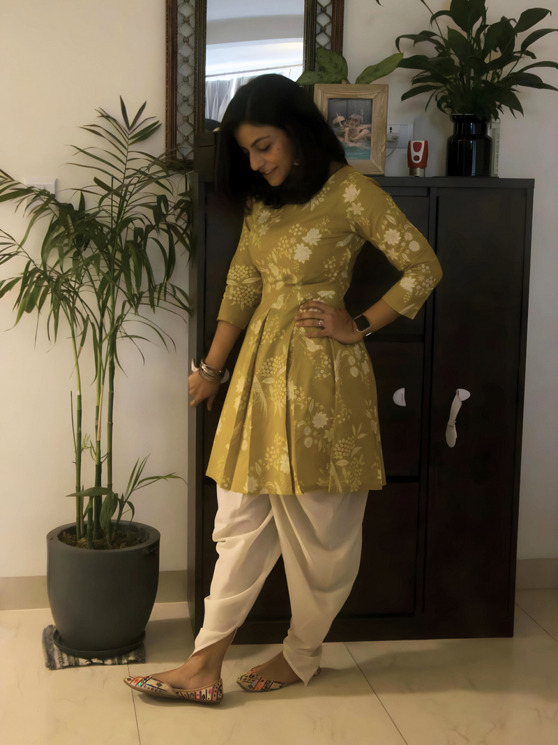 Cotton green discharge printed ,bodice fitted kurta with pleats at waist paired with off-white coloured cotton dhoti pant