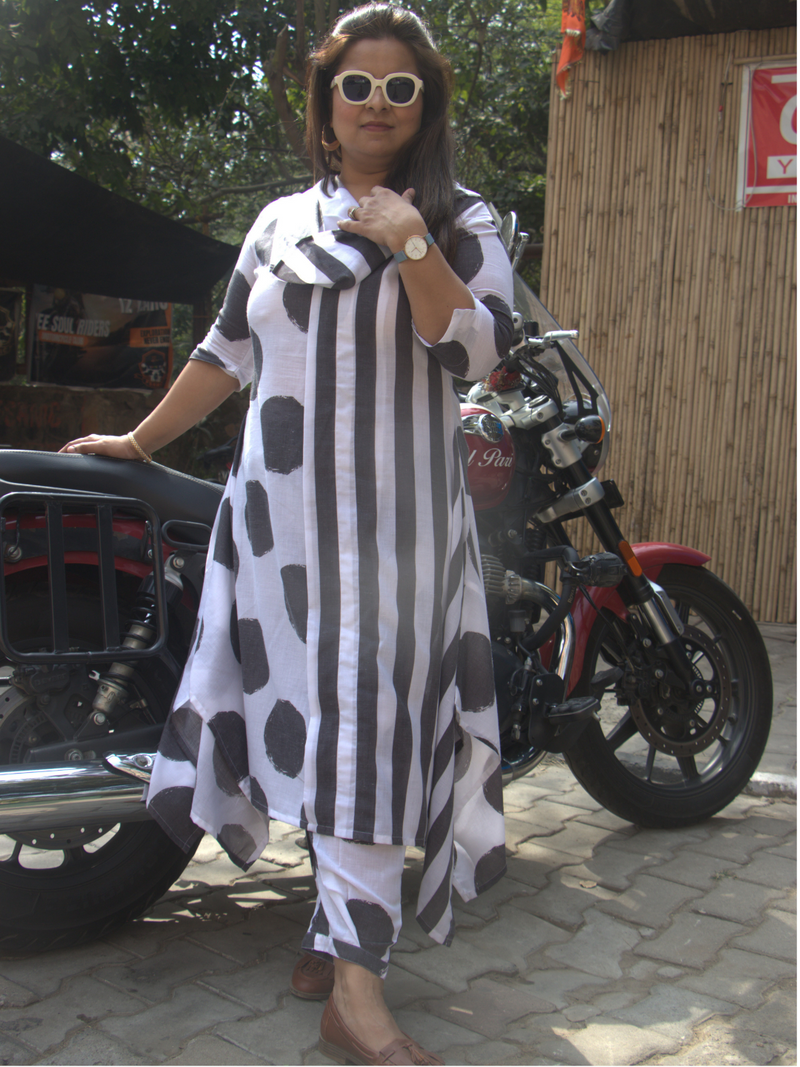 Assymetrical kurta with a cowl neck in combination of black and white polka and stripes paired with polka salwar