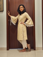 Cotton blend yellow and white stripe straight kurta with flared sleeves embellished with tassles , paired with offwhite cotton pants with curved slits