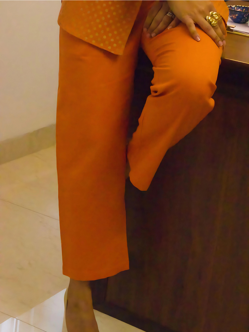 Rust coloured flex straight pants paired with same fabric single buttoned coat with khadi print