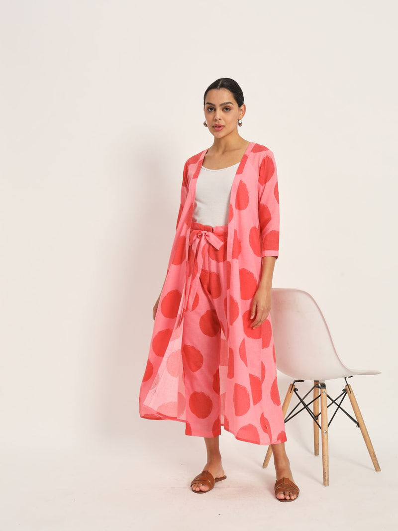 Red and pink polka cape paired with highwaisted pants.