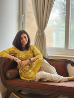 Cotton green discharge printed ,bodice fitted kurta with pleats at waist paired with off-white coloured cotton dhoti pant