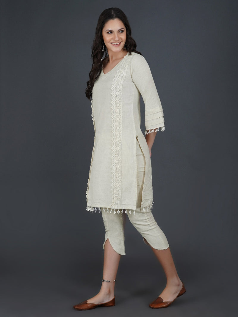 Set of off white cotton flex kurta with lace work on princess seam, tiered sleeves with co-ordinated petal pants-Kurta Set-Fabnest