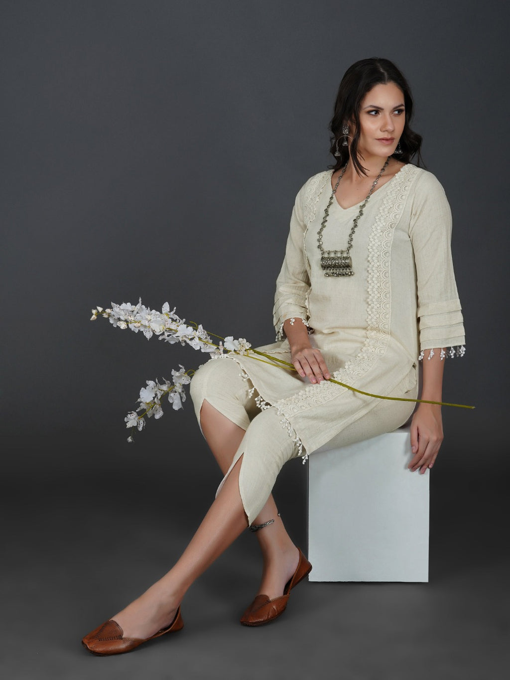 Set of off white cotton flex kurta with lace work on princess seam, tiered sleeves with co-ordinated petal pants-Kurta Set-Fabnest